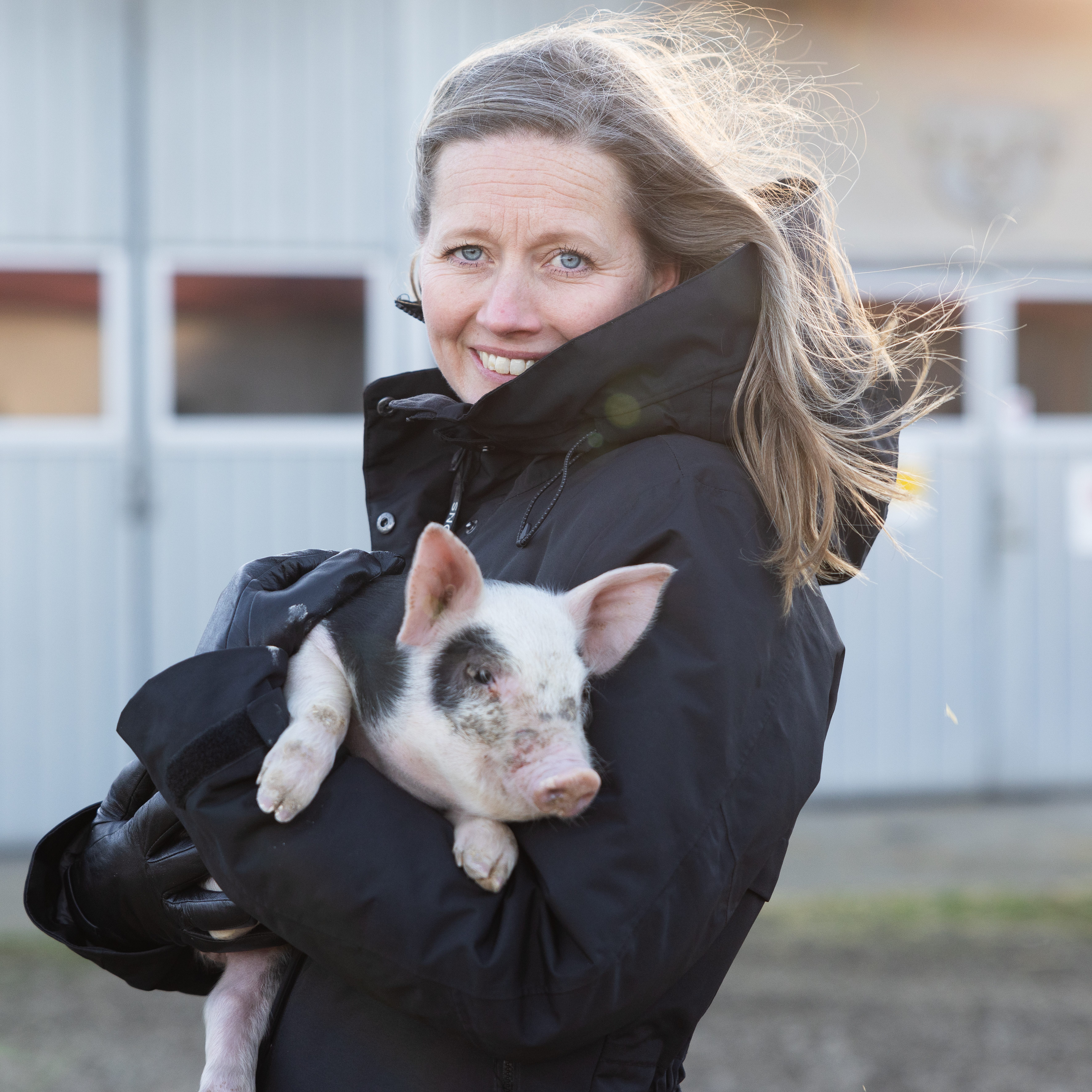 En kvinna som håller en gris